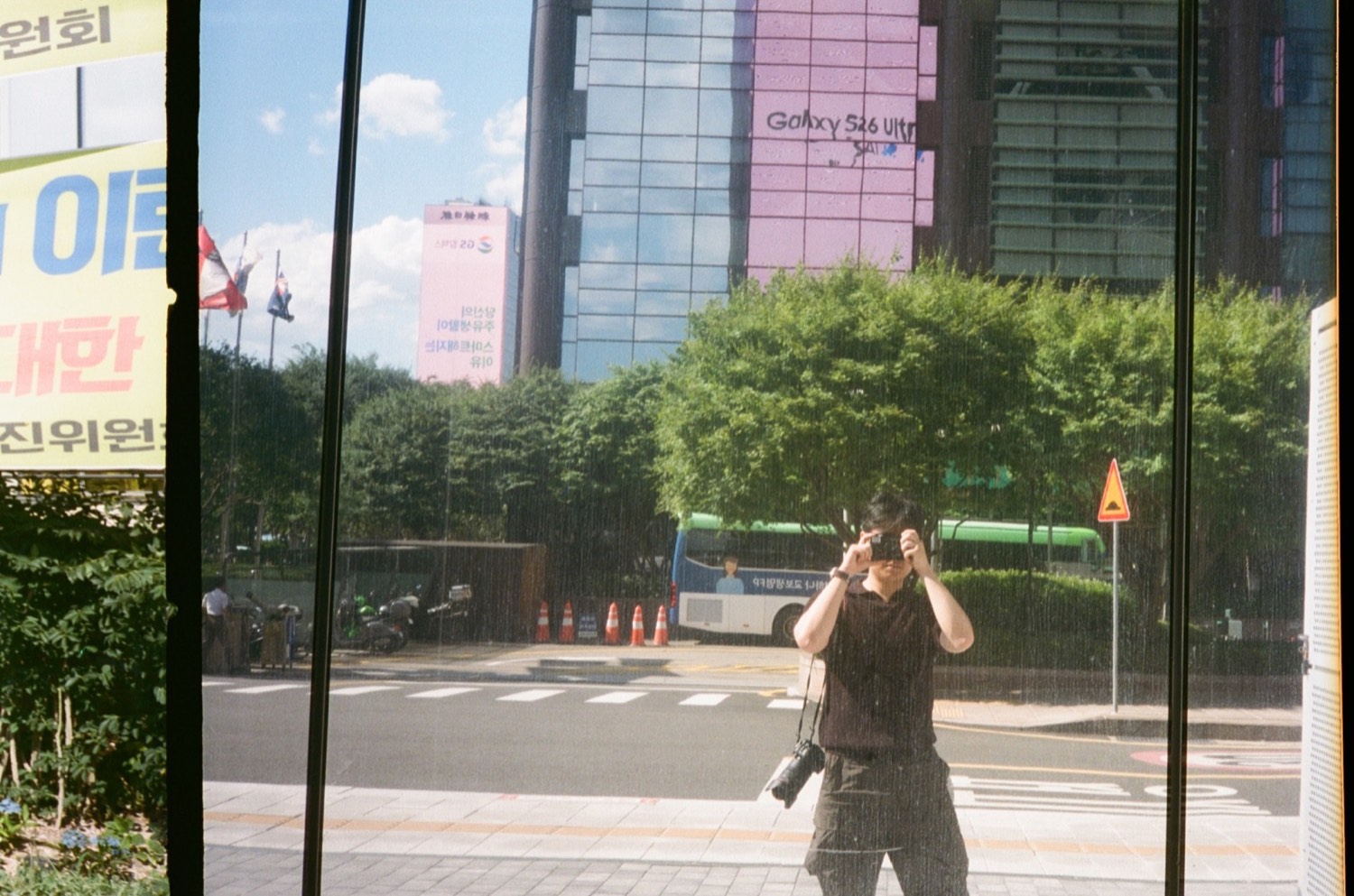 Moses Yoon photographing a street reflection